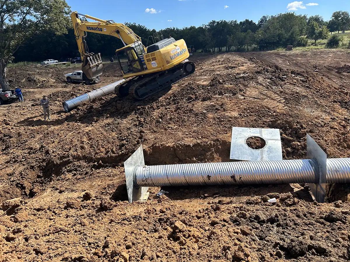 Excavator digging out a trench for underground pipe