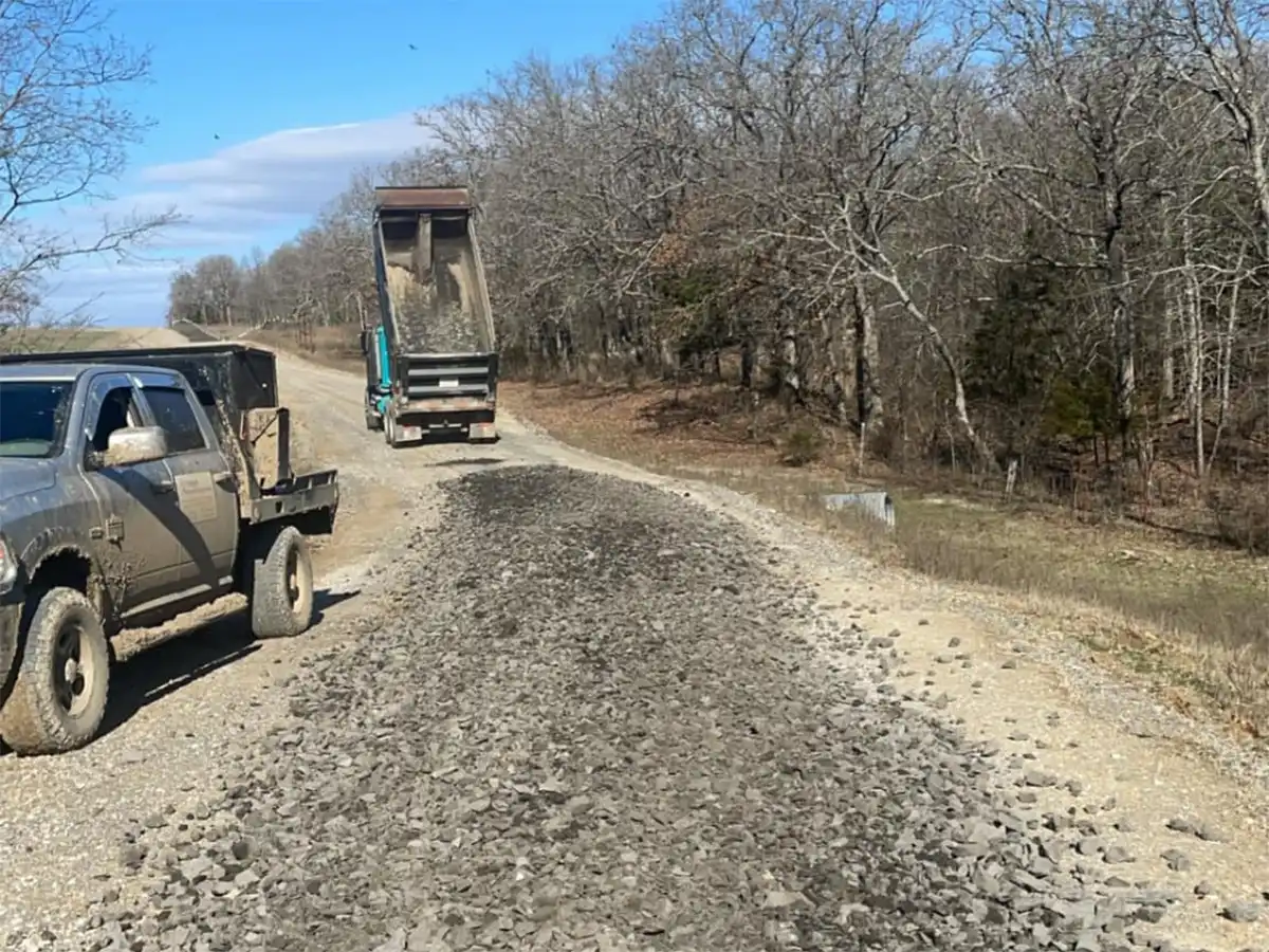 a truck laying gravel for a new road in oklahoma