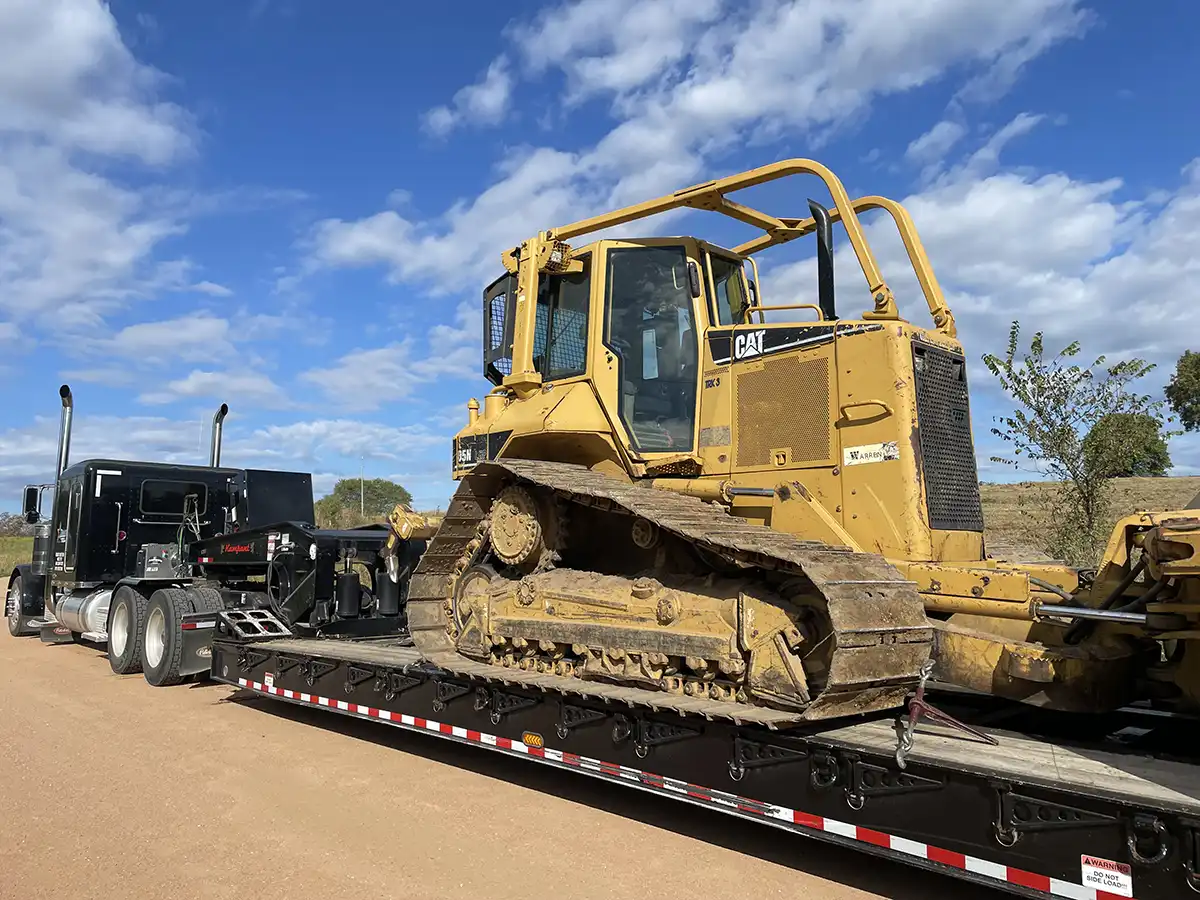 truck hauling heavy equipment